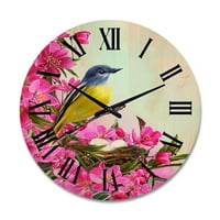 Designart 'Kis sárga madár a fészek közelében rózsaszín virágokkal' Hagyományos fa falióra