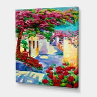 Designart 'Színes tradicionális Santorini házak a virágok között' Tengeri és parti vászon fali művészet